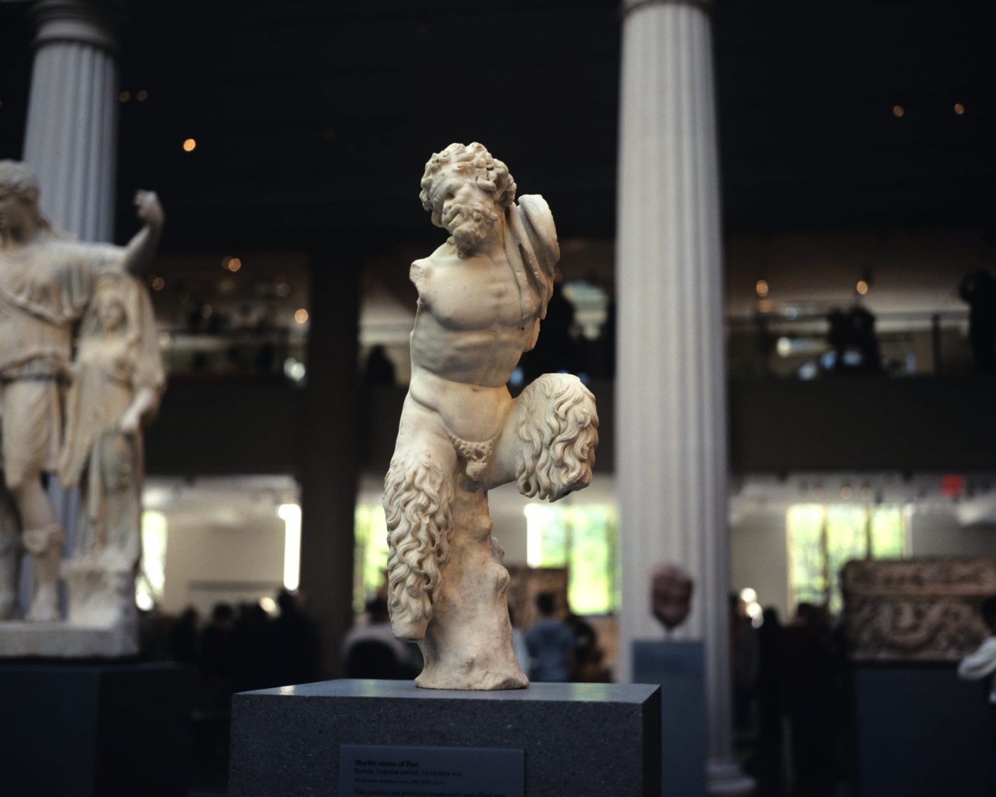 A small marble statue of a satyr at a museum